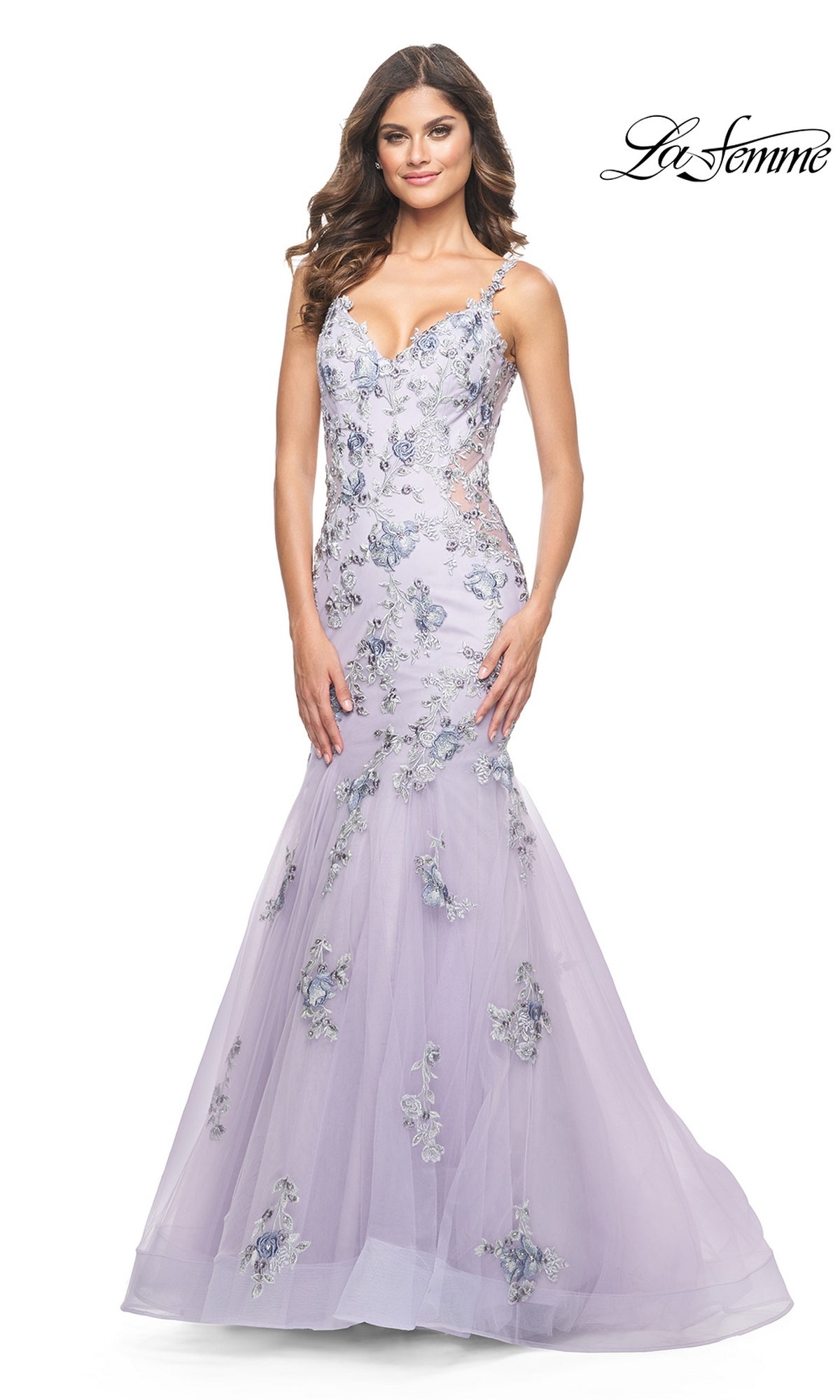 A woman models the La Femme Long Lavender Mermaid Prom Dress 32091 with floral embroidery and thin straps, standing against a white background. The La Femme logo appears in the upper right corner.